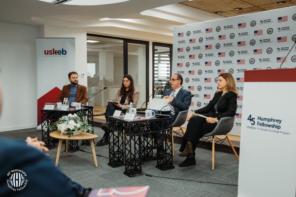 Two women and two men seated on a dais engaged in discussion while commemorating the 45th anniversary in Kosovo.