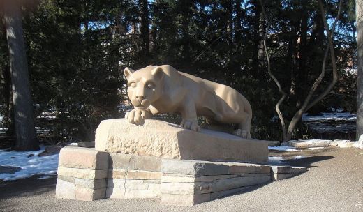 a statue of a lion on a stone block.