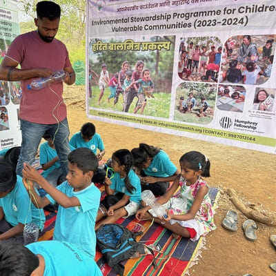 Children engaged in creative and innovative work, while a man guides and supports them