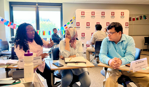 Men and women engaged in a deep conversation within a classroom at Purdue University, Indiana.