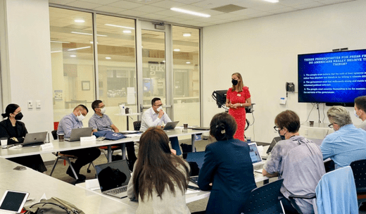A woman educator captivating the audience in a lecture hall at George Washington University.