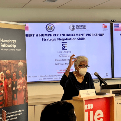 Shanta Nagendram giving a speech to the audience in a conference hall.
