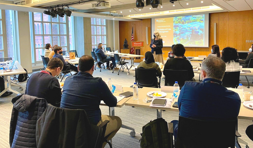 a group of people sitting at tables in a room.