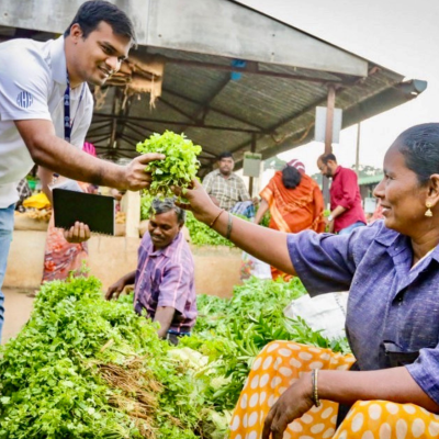 Humphrey alumnus Tanvir Ahmed interacting with small-scale farmer