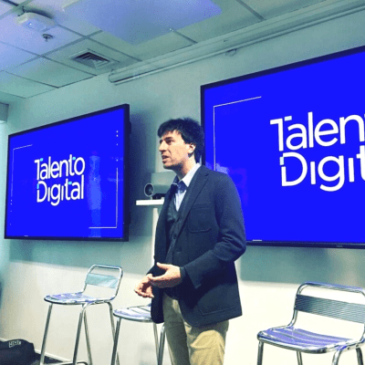 Juan Gowland taking the stage and delivering a speech.