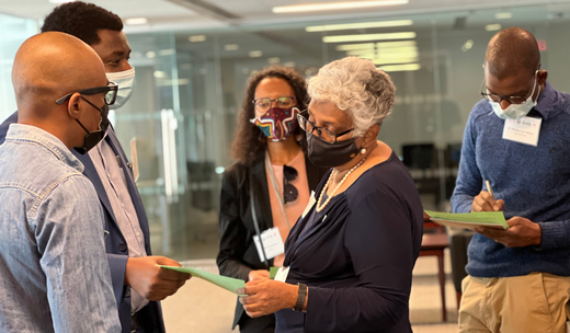 a group of people standing and discussing.