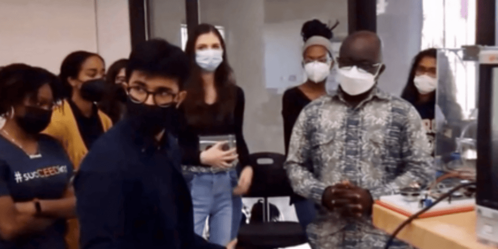 Dr. William Okyere-Frempong with other men and women working to build neo-natal incubator for newborns in Ghana.